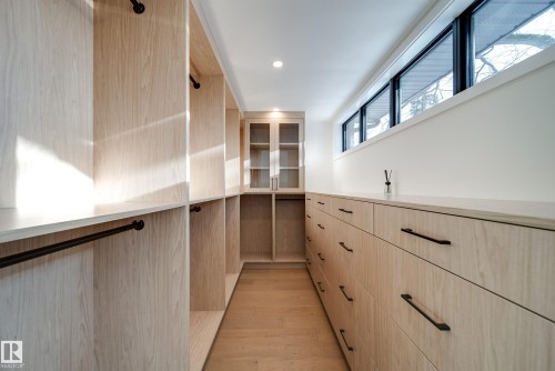 The property features a spacious closet with light wood cabinetry, including shelving, hanging rods, and an extensive bank of drawers - 13804 85 Avenue, Edmonton, AB - Indoor Photo Showing Other Room