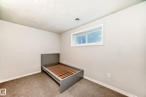 Basement bedroom with carpet floors and a textured ceiling - no closet - 14 Spring Gate, Spruce Grove, AB - Indoor Photo Showing Other Room