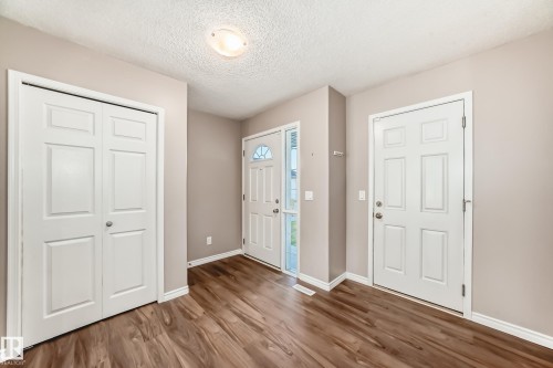 Entryway with a textured ceiling and wood finished floors - 14 Spring Gate, Spruce Grove, AB - Indoor Photo Showing Other Room