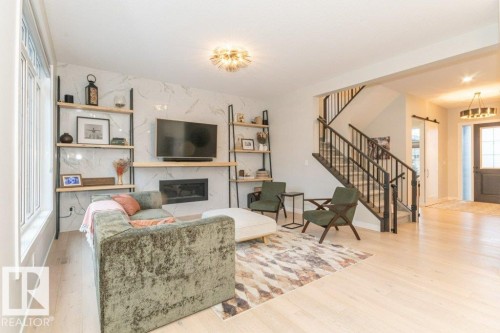 698 Howatt Drive Sw, Edmonton, AB - Indoor Photo Showing Living Room With Fireplace