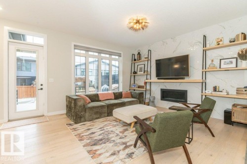 698 Howatt Drive Sw, Edmonton, AB - Indoor Photo Showing Living Room With Fireplace