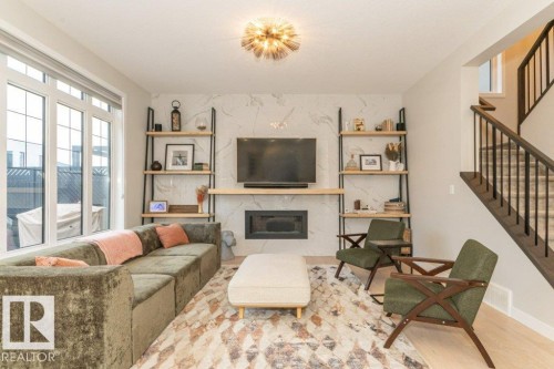 698 Howatt Drive Sw, Edmonton, AB - Indoor Photo Showing Living Room With Fireplace