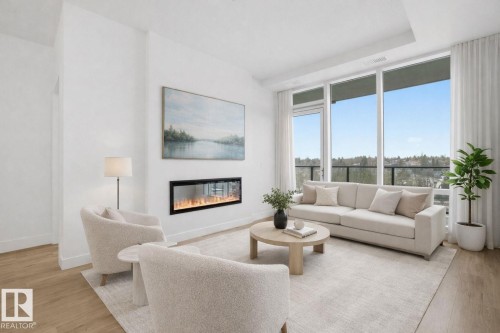 The living area features a built-in fireplace, large windows providing ample natural light, and light-toned flooring - 516 260 Bellerose Dr, St. Albert, AB - Indoor Photo Showing Living Room With Fireplace
