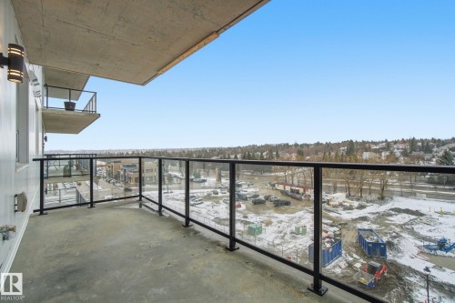 This property features a balcony with glass railings, providing an expansive view of the surrounding area and a clear sky - 516 260 Bellerose Dr, St. Albert, AB - Outdoor With Balcony With View With Exterior