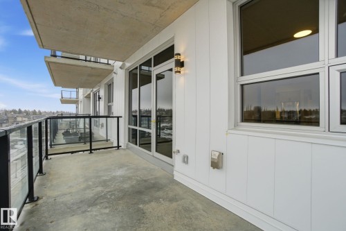 This property features a balcony with a concrete floor and a glass and metal railing, offering expansive views - 516 260 Bellerose Dr, St. Albert, AB - Outdoor With Balcony With Exterior