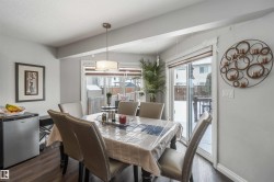 The dining area features hard flooring, a contemporary ceiling light fixture, and sliding glass doors that open to an outdoor space - 