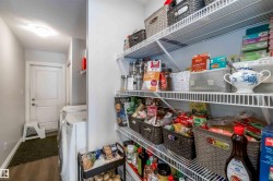 Utility area with a white door, a washing machine, and extensive wire shelving for storage - 
