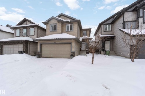 The property features a two-story design with siding and stone accents, a front-facing garage, and a welcoming front entrance - 12232 167B Avenue, Edmonton, AB - Outdoor With Facade