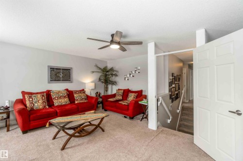 The property features a living room with carpeted flooring, light grey walls, and a ceiling fan - 12232 167B Avenue, Edmonton, AB - Indoor Photo Showing Living Room
