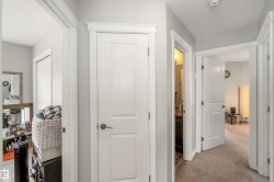 Well-maintained interior hallway with neutral wall colors and white trim - 