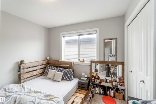 The room features a window with horizontal blinds, light gray walls, and white trim - 12232 167B Avenue, Edmonton, AB - Indoor Photo Showing Bedroom