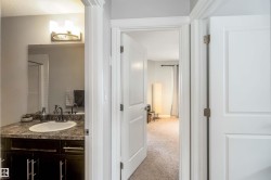 The property features a bathroom vanity with a countertop, an oval sink, and a mirror - 