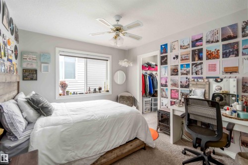 This inviting room features a window with blinds, a ceiling fan, and carpeted flooring - 12232 167B Avenue, Edmonton, AB - Indoor Photo Showing Bedroom