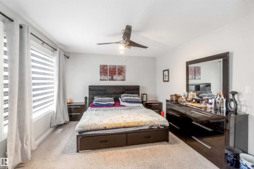 Bedroom featuring light-colored carpeting, a window with blinds and curtains, and a ceiling fan - 12232 167B Avenue, Edmonton, AB - Indoor Photo Showing Bedroom