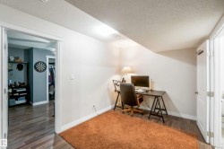 This versatile room features wood-look flooring and a recessed lighting fixture - 
