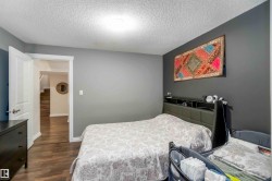 This room features hardwood flooring and a neutral color palette with contrasting accent walls - 