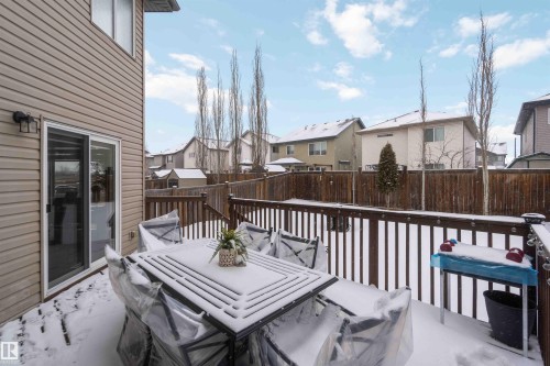 The property features an outdoor deck with a wooden railing and a sliding glass door providing access to the interior - 12232 167B Avenue, Edmonton, AB - Outdoor With Deck Patio Veranda With Exterior