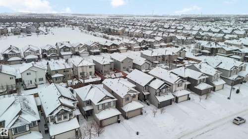Aerial view of the neighborhood, showcasing a collection of properties featuring various architectural styles, snow-covered roofs, and residential streets - 12232 167B Avenue, Edmonton, AB - Outdoor