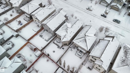Aerial view of the neighborhood showcasing several properties with snow-covered roofs and yards, and a street with parked vehicles - 12232 167B Avenue, Edmonton, AB - Other