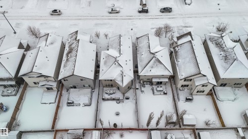 Aerial view of the property and surrounding neighborhood, featuring residential homes with pitched roofs, and a paved street with parked cars - 12232 167B Avenue, Edmonton, AB - Outdoor With View