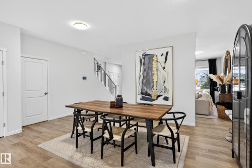 The property features light-colored walls and wood-look flooring throughout - 6127 Carr Road, Edmonton, AB - Indoor Photo Showing Dining Room