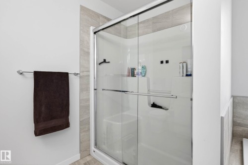 The bathroom features a shower enclosure with glass sliding doors and a chrome towel bar - 6127 Carr Road, Edmonton, AB - Indoor Photo Showing Bathroom