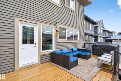 Exterior deck with light wood-tone flooring and a black metal railing - 6127 Carr Road, Edmonton, AB - Outdoor With Deck Patio Veranda With Exterior