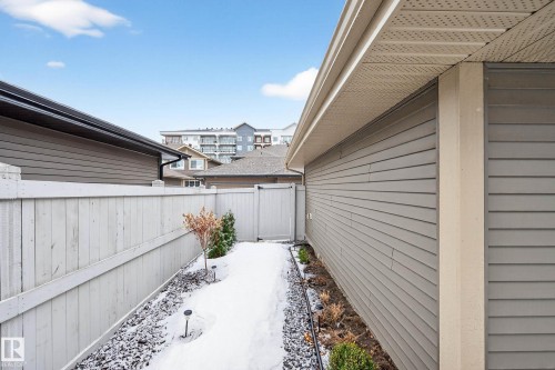 The property features a well-maintained exterior with siding, a rain gutter system, and a fenced yard with a small pathway - 6127 Carr Road, Edmonton, AB - Outdoor With Exterior
