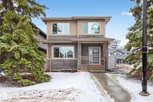 The property features a two-story exterior with a combination of brick and siding finishes - 6127 Carr Road, Edmonton, AB - Outdoor With Facade