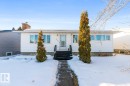 The property features a white exterior with white window frames and a chimney - 7324 77 Street, Edmonton, AB  - Outdoor 