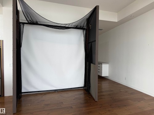 This versatile room features hardwood flooring and white walls, offering a bright and expansive space - 710 2504 109 Street, Edmonton, AB - Indoor Photo Showing Other Room