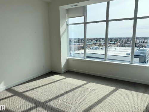 This room features expansive floor-to-ceiling windows, offering broad views of the surrounding area - 710 2504 109 Street, Edmonton, AB - Indoor Photo Showing Other Room
