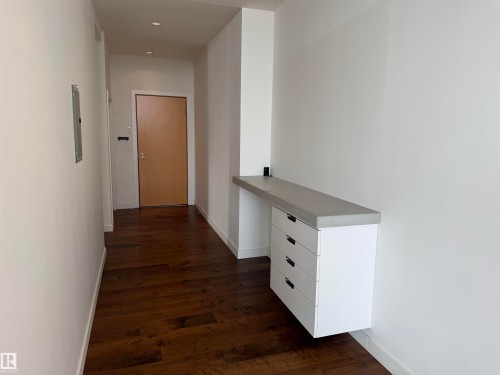 Entryway featuring dark hardwood flooring, recessed lighting, and a built-in storage unit with a light-colored countertop - 710 2504 109 Street, Edmonton, AB - Indoor Photo Showing Other Room
