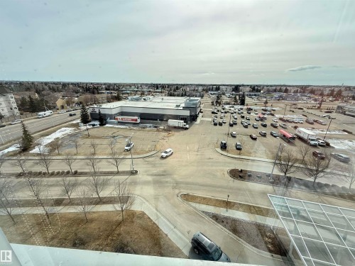 Overhead view showcasing the surrounding area, including a paved road, parking areas, and various buildings - 710 2504 109 Street, Edmonton, AB -  With View
