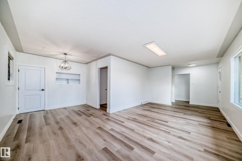 Spacious interior with light wood-tone flooring, white walls, and recessed shelving - 9126 152 St, Edmonton, AB - Indoor Photo Showing Other Room