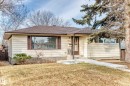The property features horizontal siding, a brown shingled roof, a front door with a storm door, and a concrete pathway leading to the entrance - 9126 152 St, Edmonton, AB  - Outdoor 