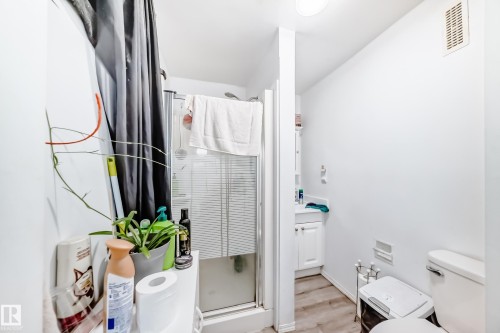 Bathroom featuring a glass-enclosed shower, a vanity with a white cabinet, and a toilet - 9126 152 St, Edmonton, AB - Indoor Photo Showing Bathroom