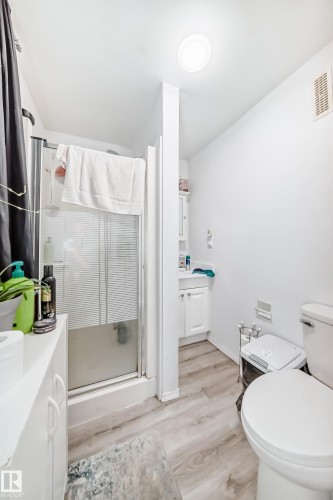 Bathroom featuring a shower stall with a clear glass door, a white vanity with cabinet storage, and light-toned flooring - 9126 152 St, Edmonton, AB - Indoor Photo Showing Bathroom