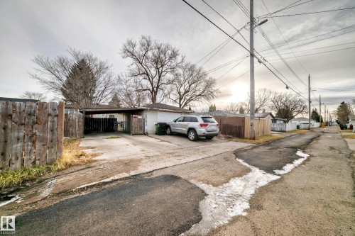 This property includes a detached garage with a covered car port and a concrete driveway - 9126 152 St, Edmonton, AB - Outdoor
