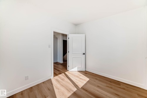 Room featuring light-toned wood flooring and white walls - 7220 152A Ave, Edmonton, AB - Indoor Photo Showing Other Room