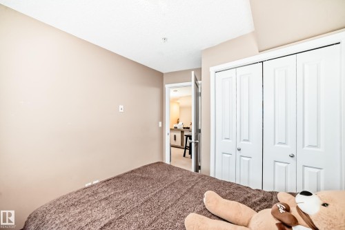 The interior space features light-colored walls and white bi-fold closet doors - 116 5810 Mullen Place, Edmonton, AB - Indoor