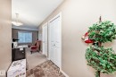 Hallway featuring tile flooring, neutral wall paint, and white bifold doors - 116 5810 Mullen Place, Edmonton, AB  - Indoor Photo Showing Other Room 