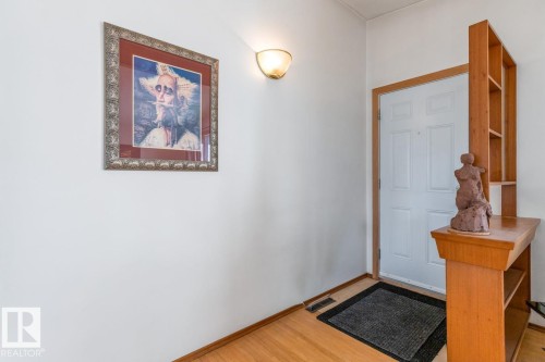 Entryway featuring a white paneled door and wood-finish flooring - 13437 118 Street, Edmonton, AB - Indoor Photo Showing Other Room