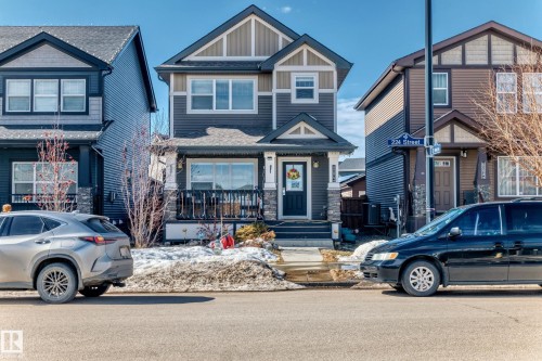 The property features a charming exterior with dark siding and light trim accents - 8204 224 Nw, Edmonton, AB - Outdoor With Facade