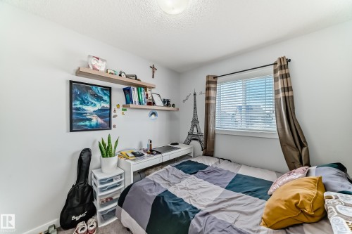 This room features a window with horizontal blinds and curtains, offering natural light - 8204 224 Nw, Edmonton, AB - Indoor Photo Showing Bedroom