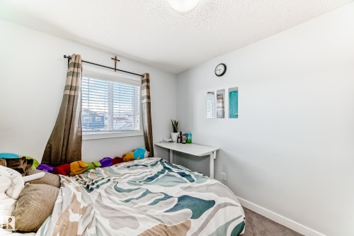 This room features a window with blinds and drapes, carpeted flooring, and a neutral color palette - 8204 224 Nw, Edmonton, AB - Indoor Photo Showing Bedroom