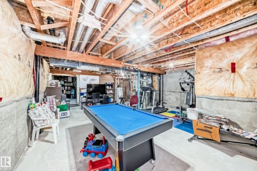 The property features an unfinished basement with exposed wooden beams and concrete walls, offering significant potential for future customization - 8204 224 Nw, Edmonton, AB - Indoor Photo Showing Basement