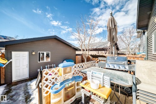 The property features a detached exterior building with horizontal siding and a white entry door - 8204 224 Nw, Edmonton, AB - Outdoor