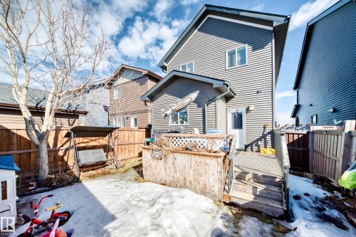 The property features a private yard with a wooden fence and a multi-level wooden deck - 8204 224 Nw, Edmonton, AB - Outdoor