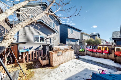 The property features a fenced backyard with a patio area and a wooden planter box - 8204 224 Nw, Edmonton, AB - Outdoor